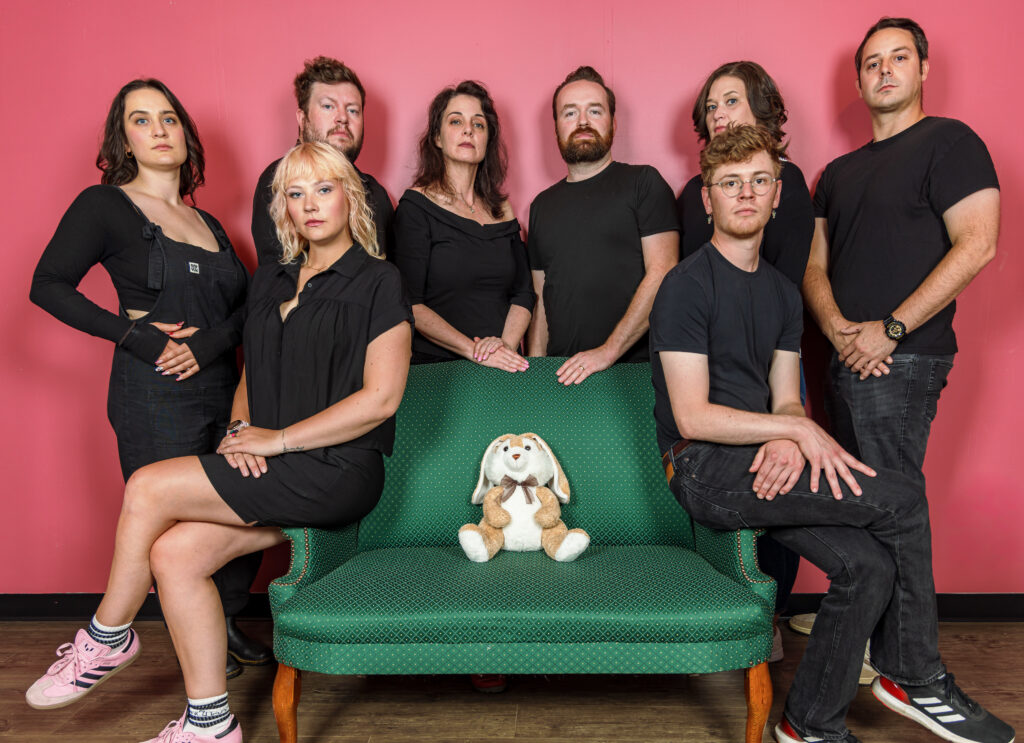 Primary Cast of Rocky Mountain High around a couch with Hugz Bunny on a green couch